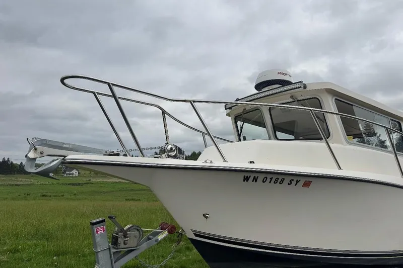 Slide: The Image of 2020 Defiance San Juan 250 boat on trailer, overcast sky background. - 20