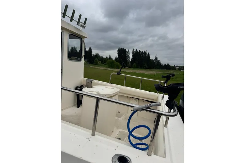 Slide: The Image of 2020 Defiance San Juan 250 boat interior with fishing rod holders and open deck. - 4