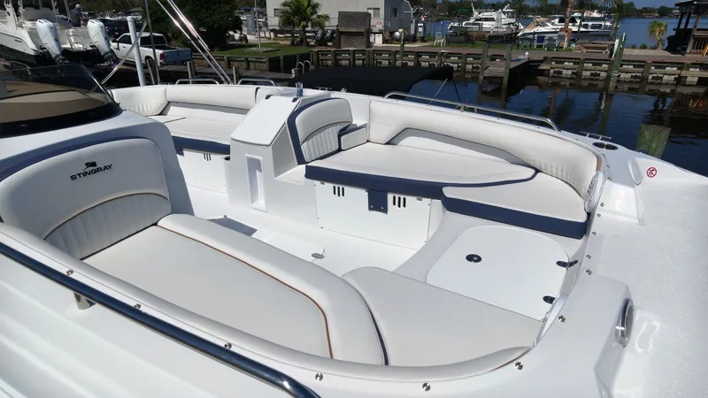 Slide: The Image of The image shows the spacious cockpit of a Stingray 192 SC boat with white upholstery. - 15
