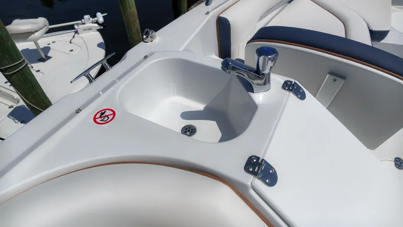 Slide: The Image of The image shows a white sink with a faucet on a boat. - 11