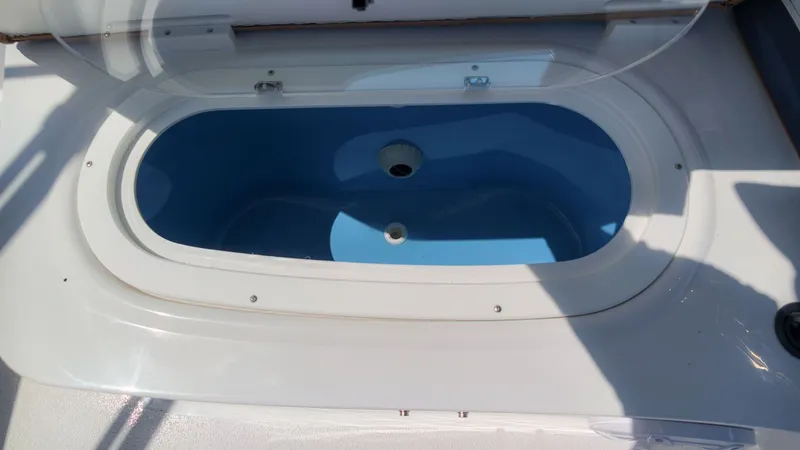 Slide: The Image of An open, oval compartment on a boat, possibly a storage area or livewell. - 8