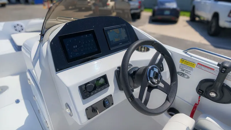 Slide: The Image of The image shows the cockpit of a Stingray 192 SC boat with modern instruments and steering wheel. - 23