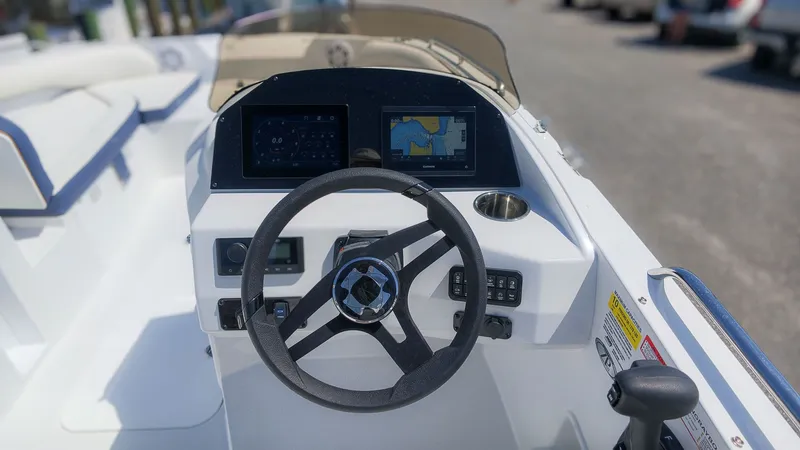 Slide: The Image of The image shows the cockpit of a Stingray 192 SC boat with a modern helm. - 22