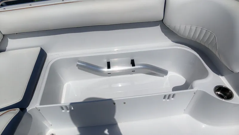 Slide: The Image of The image shows the white interior of a boat with cushioned seating and a cup holder. - 10