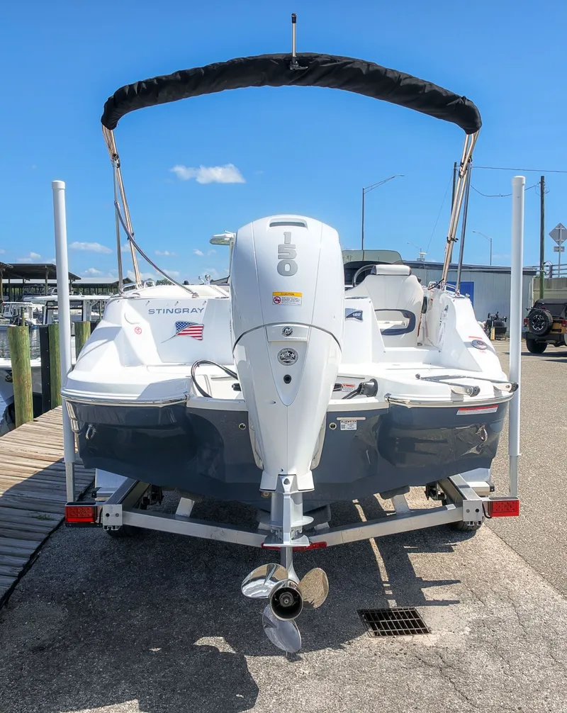 Slide: The Image of The image shows a 2027 Stingray 192 SC boat with an outboard motor, sitting on a trailer. - 5