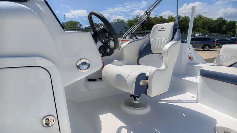Slide: The Image of The image shows the helm of a Stingray 192 SC boat with a white seat and steering wheel. - 20
