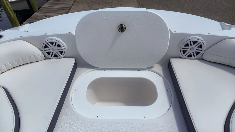 Slide: The Image of The image shows the bow area of a Stingray 192 SC boat with white cushions and speakers. - 18