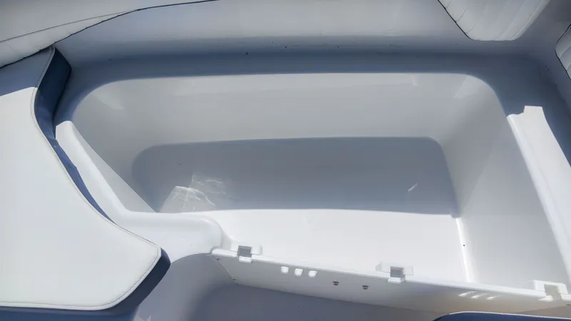 Slide: The Image of A spacious, white storage compartment inside a boat, surrounded by cushioned seating. - 17
