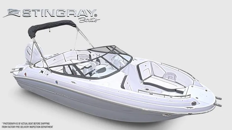 Slide: The Image of Stingray 211 DC boat with open deck, bimini top, and sleek white finish. - 8