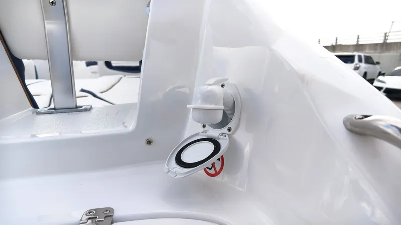Slide: The Image of Close-up of a white boat deck with a round cover and a handle. - 9