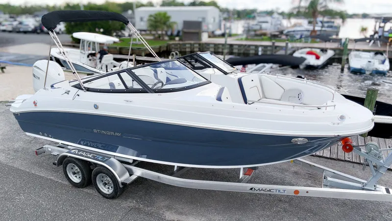 Slide: The Image of A modern 2027 Stingray 211 DC on a trailer, ready for adventures on the water. - 3