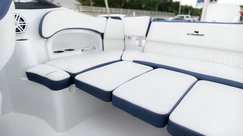 Slide: The Image of The 2027 Stingray 211 DC features a luxurious, cushioned seating area with blue accents. - 12