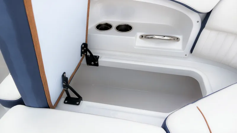 Slide: The Image of An open storage compartment on a boat with two cup holders and a handle. - 13