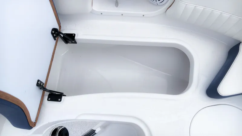 Slide: The Image of The image shows an open storage compartment in a boat with white and blue upholstery. - 21
