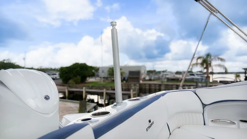 Slide: The Image of The image shows the cockpit of a Stingray 211 DC boat with white upholstery and blue accents. - 10