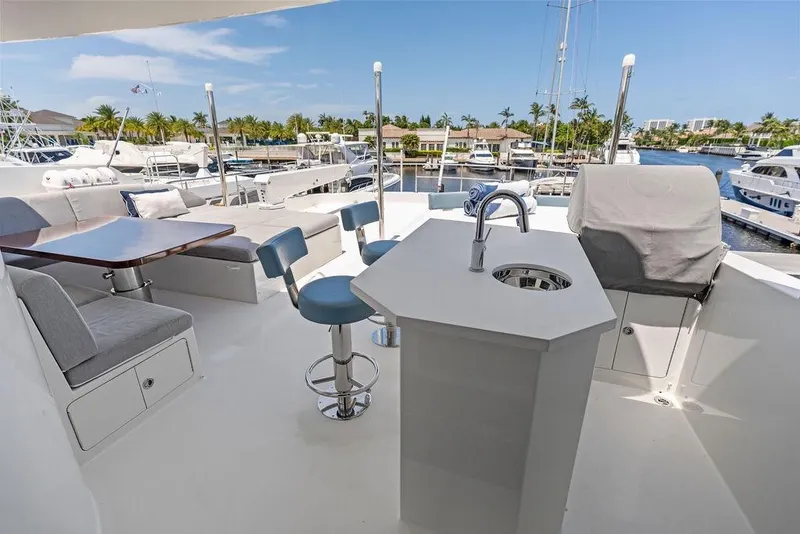 Slide: The Image of Luxurious deck of 2012 Ocean Alexander 90 Skylounge Motoryacht with seating and bar area. - 28