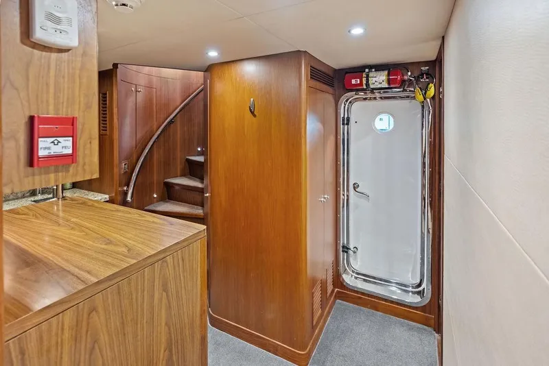 Slide: The Image of Interior of 2012 Ocean Alexander 90 Skylounge Motoryacht with wooden finishes and safety features. - 99