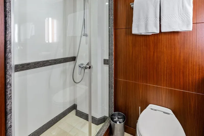 Slide: The Image of Luxurious bathroom in 2012 Ocean Alexander 90 Skylounge Motoryacht with shower and wooden accents. - 86