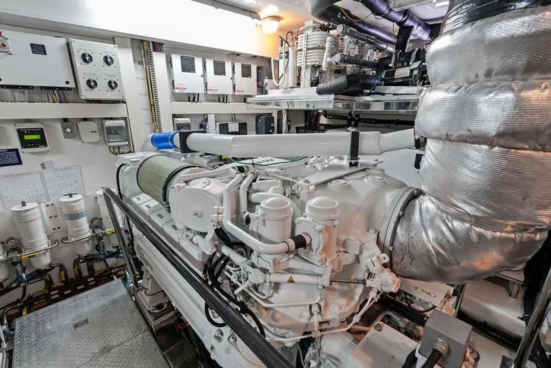 Slide: The Image of Engine room of 2012 Ocean Alexander 90 Skylounge Motoryacht, showcasing advanced machinery and controls. - 101