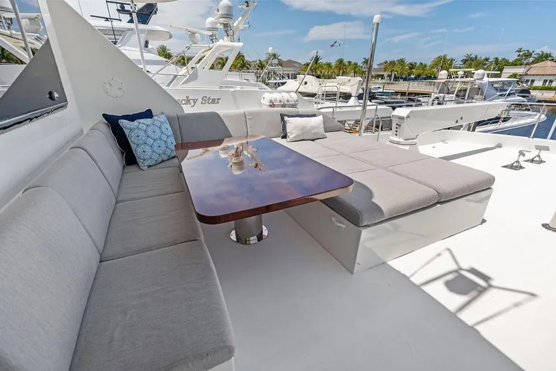Slide: The Image of Luxurious seating area on 2012 Ocean Alexander 90 Skylounge Motoryacht, featuring plush cushions and elegant table. - 31