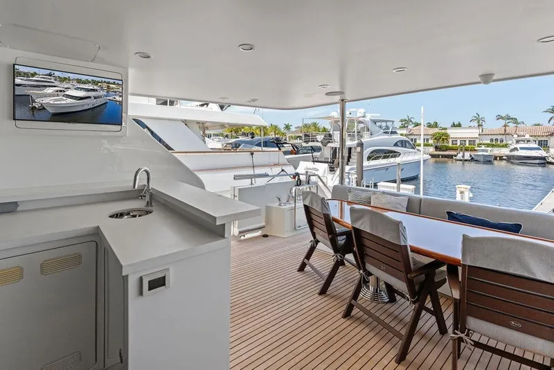 Slide: The Image of Luxurious 2012 Ocean Alexander 90 Skylounge Motoryacht deck with seating and marina view. - 16