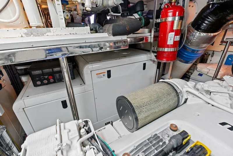 Slide: The Image of Engine room of 2012 Ocean Alexander 90 Skylounge Motoryacht with generator and fire extinguisher. - 110