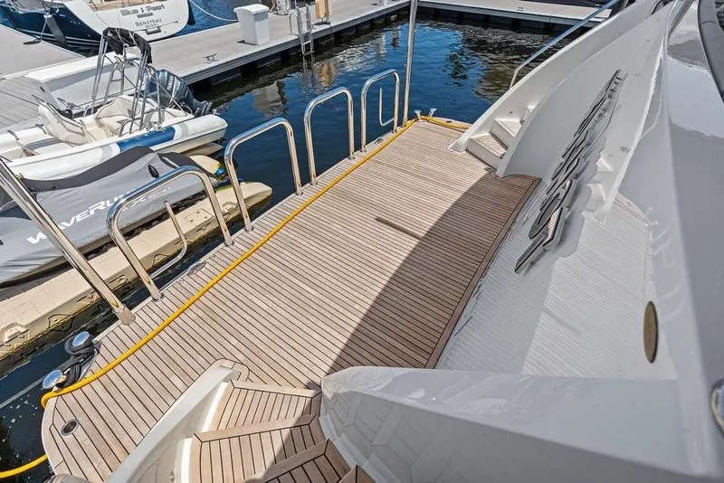 Slide: The Image of 2012 Ocean Alexander 90 Skylounge Motoryacht's teak swim platform at marina. - 11