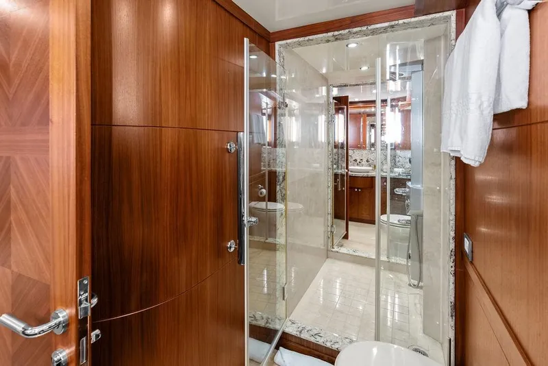 Slide: The Image of Luxurious bathroom in 2012 Ocean Alexander 90 Skylounge Motoryacht with wood paneling and glass shower. - 80