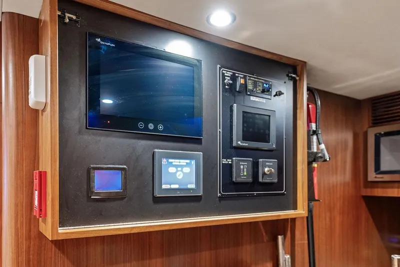 Slide: The Image of Control panel on 2012 Ocean Alexander 90 Skylounge Motoryacht, featuring advanced navigation systems. - 98