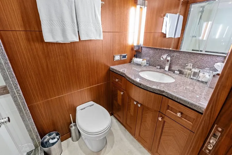 Slide: The Image of Luxurious bathroom in 2012 Ocean Alexander 90 Skylounge Motoryacht with wood cabinetry and granite countertop. - 85