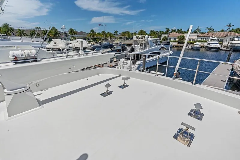 Slide: The Image of 2012 Ocean Alexander 90 Skylounge Motoryacht docked at marina under clear blue sky. - 33