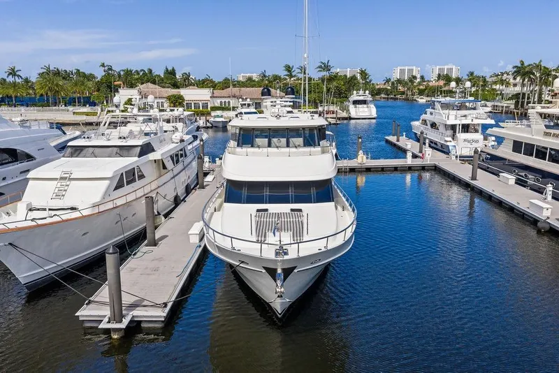 Slide: The Image of 2012 Ocean Alexander 90 Skylounge Motoryacht docked at a marina, surrounded by other luxury yachts. - 5