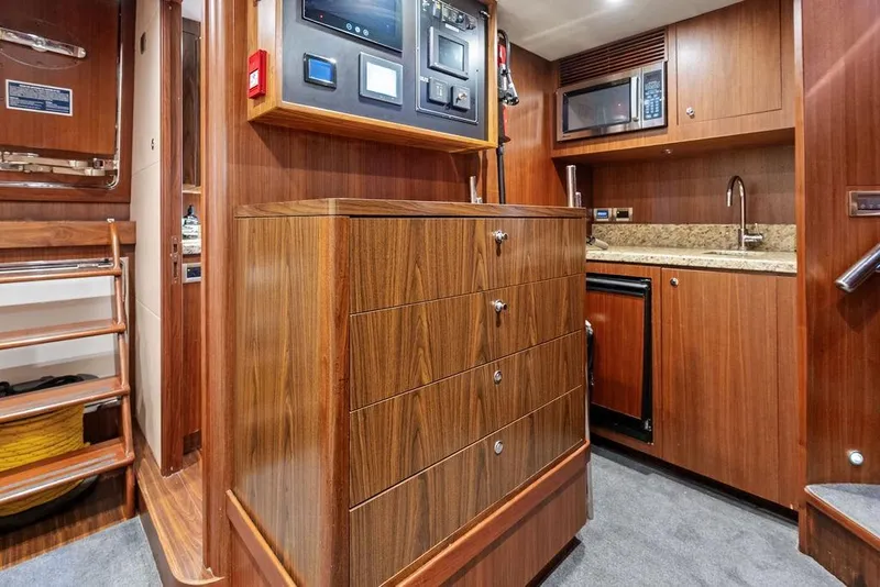 Slide: The Image of Luxurious wood-finished interior of 2012 Ocean Alexander 90 Skylounge Motoryacht kitchen area. - 97
