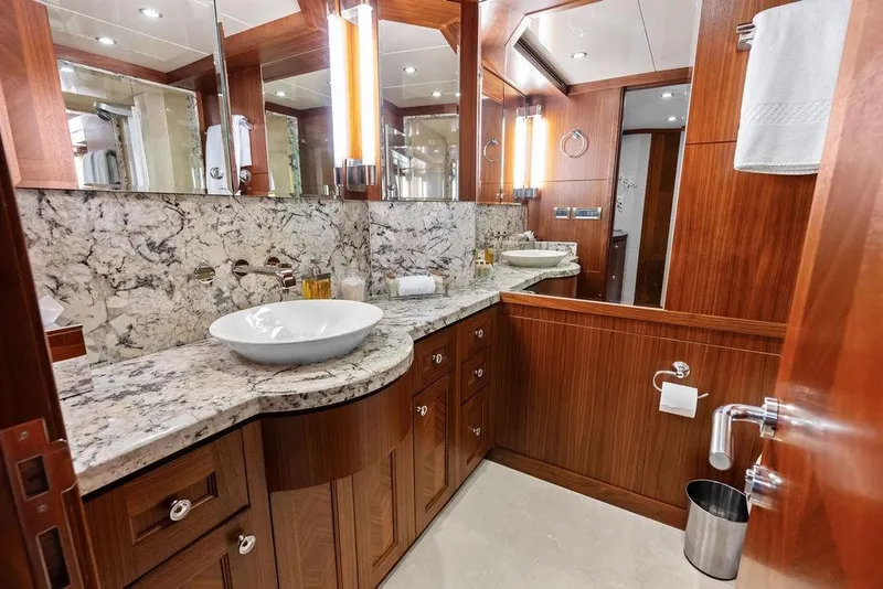 Slide: The Image of Luxurious bathroom in 2012 Ocean Alexander 90 Skylounge Motoryacht with marble countertop and wood cabinetry. - 76