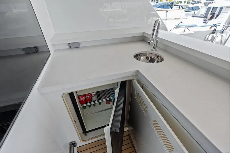 Slide: The Image of Luxurious 2012 Ocean Alexander 90 Skylounge yacht kitchenette with sink and mini fridge. - 18