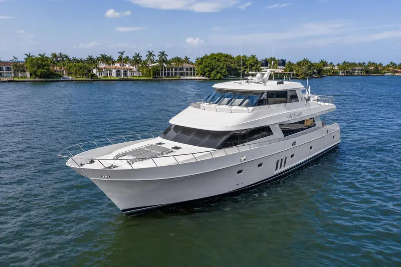 Slide: The Image of 2012 Ocean Alexander 90 Skylounge Motoryacht cruising on a serene waterway. - 1