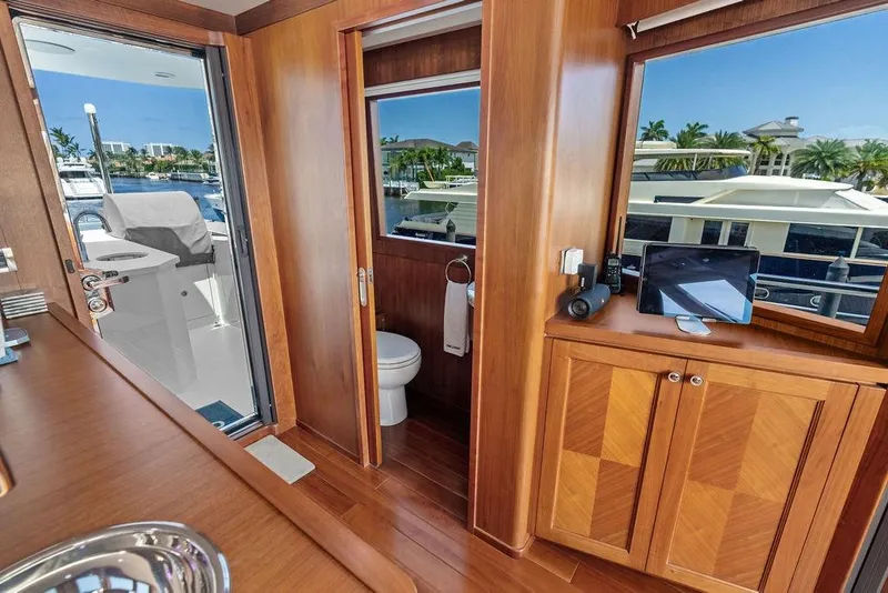 Slide: The Image of Luxurious interior of 2012 Ocean Alexander 90 Skylounge Motoryacht with wood finishes and marina view. - 34