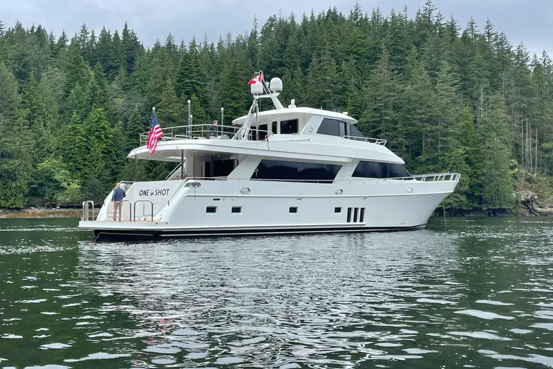 Slide: The Image of Ocean Alexander 90 Skylounge Motoryacht 2012 on serene water, surrounded by lush forest. - 3