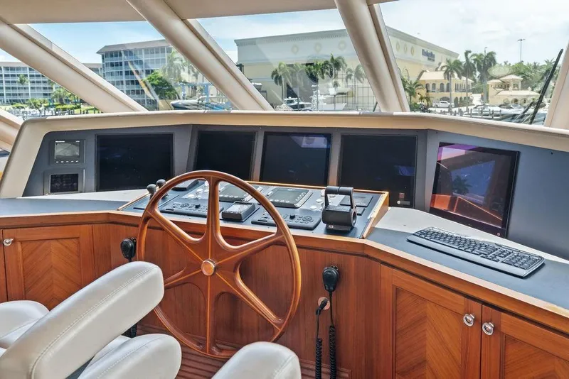 Slide: The Image of Helm of 2012 Ocean Alexander 90 Skylounge Motoryacht with wooden steering wheel and navigation screens. - 41