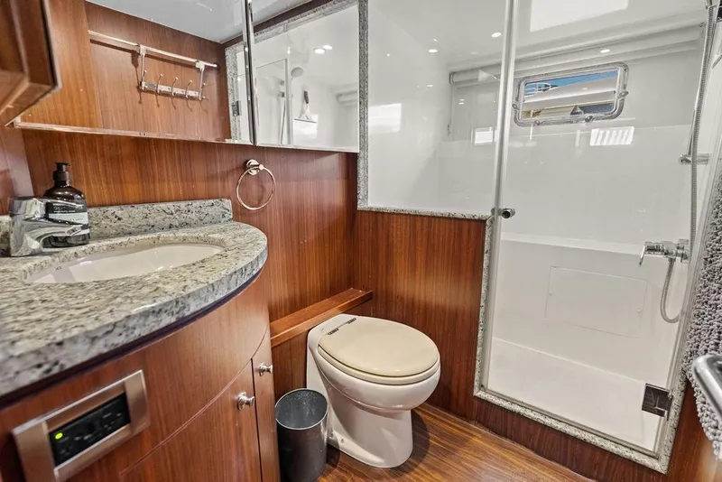Slide: The Image of Luxurious bathroom in 2012 Ocean Alexander 90 Skylounge Motoryacht with granite countertop and shower. - 96