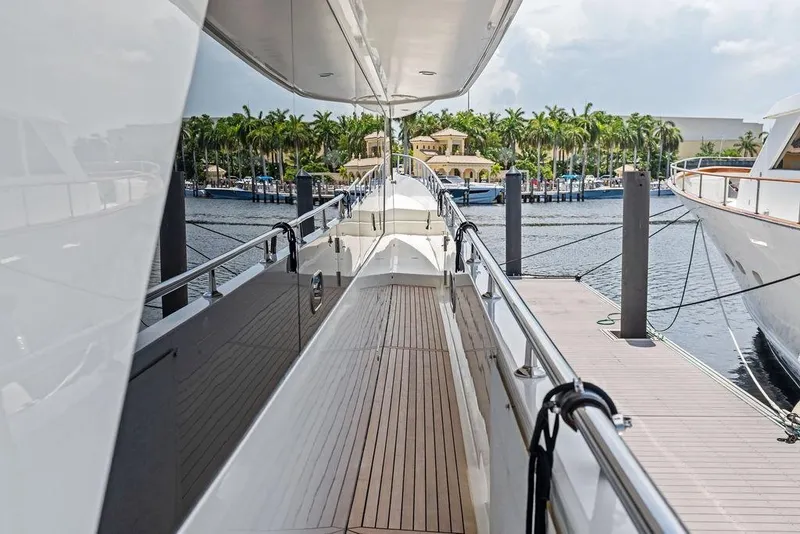 Slide: The Image of Luxurious Ocean Alexander 90 Skylounge Motoryacht docked, showcasing sleek design and spacious deck. - 24