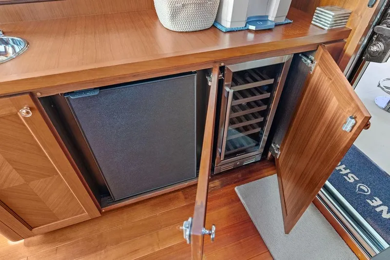 Slide: The Image of Wooden cabinetry with mini fridge and wine cooler on 2012 Ocean Alexander 90 Skylounge Motoryacht. - 36