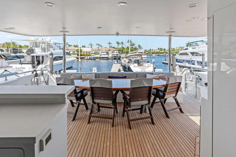 Slide: The Image of Luxurious Ocean Alexander 90 Skylounge Motoryacht deck with elegant seating, docked at marina. - 17