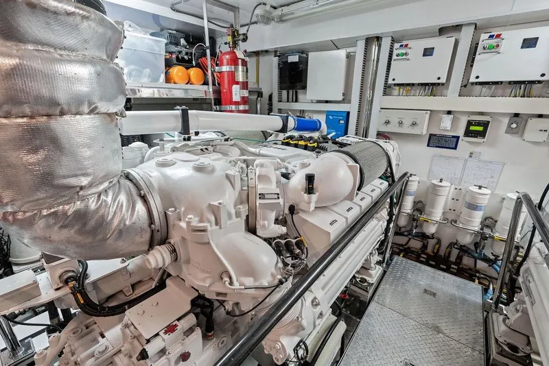 Slide: The Image of Engine room of 2012 Ocean Alexander 90 Skylounge Motoryacht, showcasing machinery and control panels. - 102
