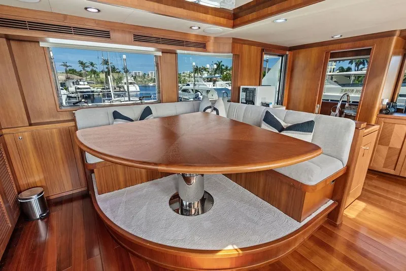 Slide: The Image of Luxurious dining area on 2012 Ocean Alexander 90 Skylounge Motoryacht with wood finish and plush seating. - 39