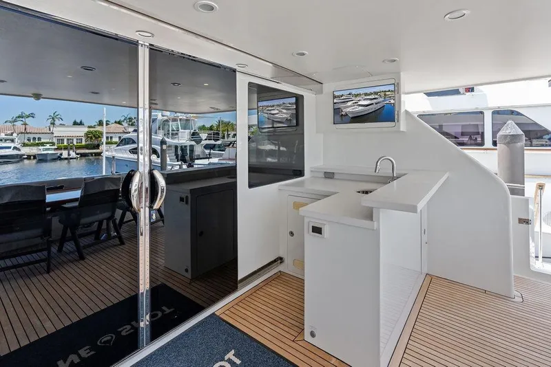 Slide: The Image of Luxurious 2012 Ocean Alexander 90 Skylounge Motoryacht with sleek outdoor seating and bar area. - 15