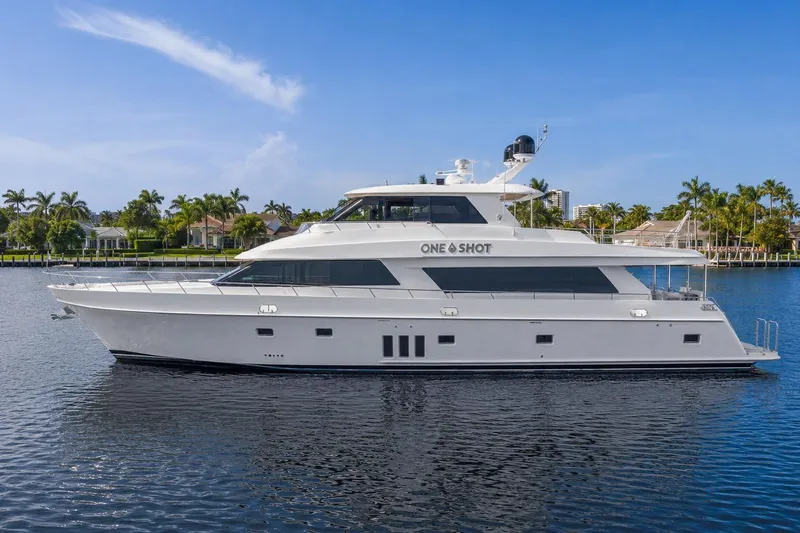 The Image of 2012 Ocean Alexander 90 Skylounge Motoryacht on calm water, surrounded by palm trees. - 0