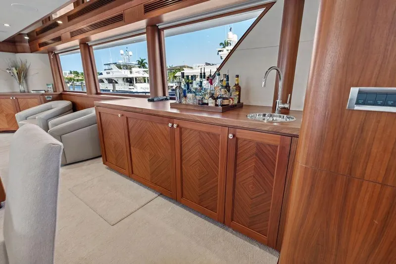 Slide: The Image of Luxurious interior of 2012 Ocean Alexander 90 Skylounge Motoryacht with elegant wood cabinetry and bar. - 59