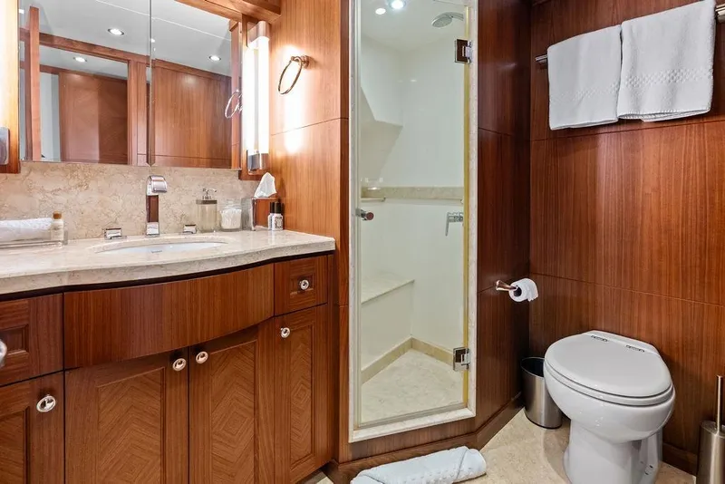 Slide: The Image of Luxurious bathroom in 2012 Ocean Alexander 90 Skylounge Motoryacht with wood cabinetry and marble accents. - 90