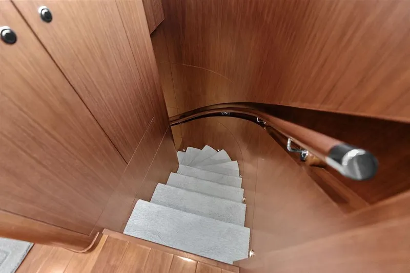 Slide: The Image of Curved wooden staircase inside 2012 Ocean Alexander 90 Skylounge Motoryacht. - 66